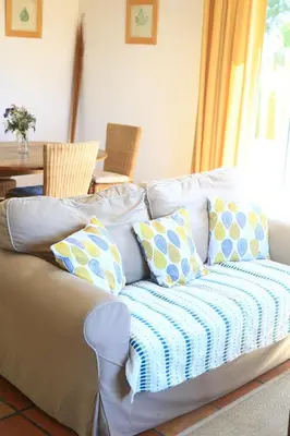 a couch with pillows on it in a living room at Gites de Labadie in Lautrec