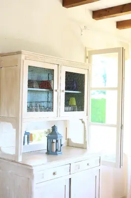 a white cabinet with two windows in a room at Gites de Labadie in Lautrec
