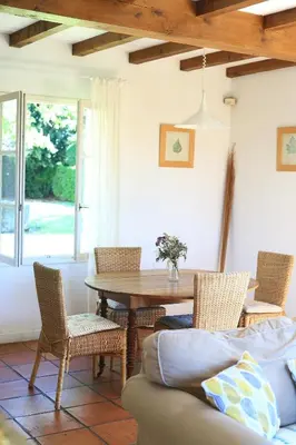 a dining room with a wooden table and chairs at Gites de Labadie in Lautrec