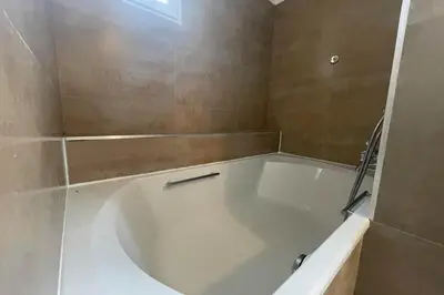 a white bath tub in a bathroom with a window at Maison au cœur des Corbières in Saint-Laurent-de-la-Cabrerisse