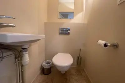 a bathroom with a white toilet and a sink at Maison au cœur des Corbières in Saint-Laurent-de-la-Cabrerisse