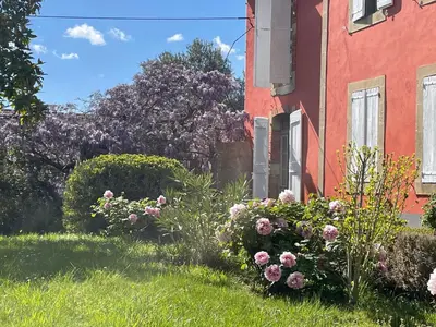 a garden of flowers in front of a building at Domaine La Belle Histoire - Gîte côté Parc in Besset