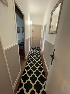 a hallway with a black and white patterned floor at Domaine La Belle Histoire - Gîte côté Parc in Besset
