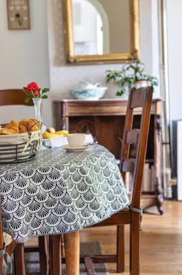 a dining room table with a table cloth on a table at Domaine La Belle Histoire - Gîte côté jardin in Besset