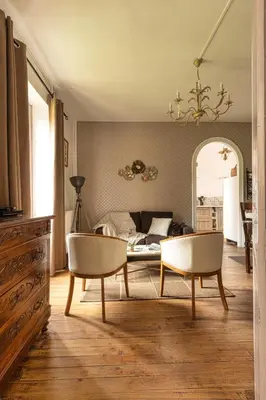 a living room with two chairs and a couch at Domaine La Belle Histoire - Gîte côté jardin in Besset