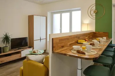 a dining room with a table with food on it at Magnifique T3 centre ville avec WIFI RDC in Limoux
