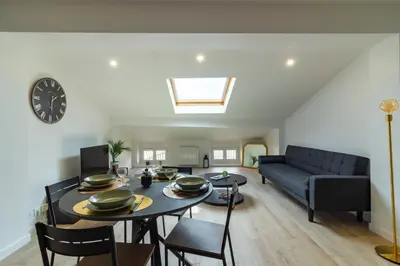 a living room with a table and a couch at Charmant duplex Castelnaudary in Castelnaudary