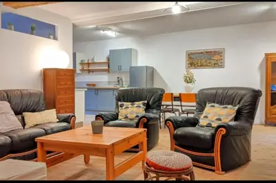 a living room with two leather chairs and a table at Grand gîte au cœur des Pyrénées - Ariège Mijanes in Mijanès
