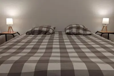 a bedroom with a bed with two pillows on it at Grand gîte au cœur des Pyrénées - Ariège Mijanes in Mijanès