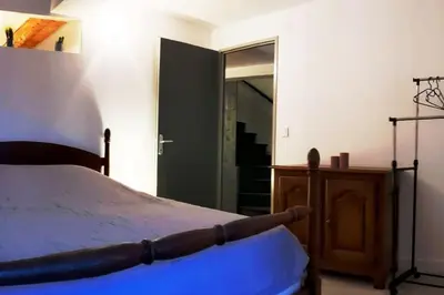a bedroom with a bed and a large mirror at Grand gîte au cœur des Pyrénées - Ariège Mijanes in Mijanès