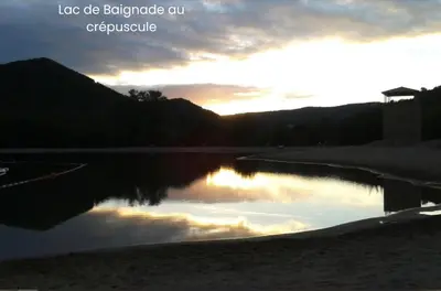 a reflection of the sunset in a body of water at chambre et salle de bain privé s'ouvrant sur terrasse, jardin et cuisine d'été in Quillan