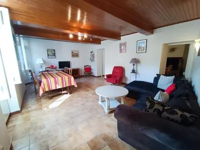 a living room with a couch and a table at Maison de village 8 couchages in La Livinière