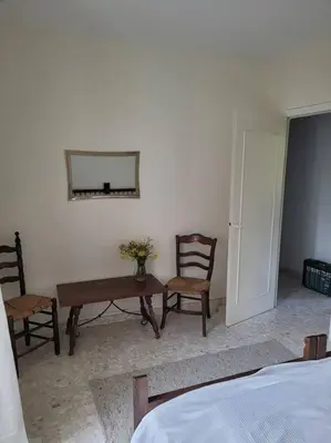 a room with a table and two chairs and a mirror at Casa Allègre in Aigne