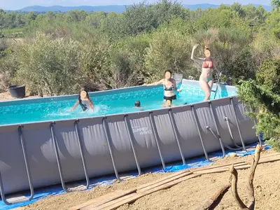 a group of people in a swimming pool at Casa Allègre in Aigne