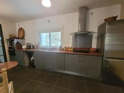 a kitchen with grey cabinets and a window in it at Casa Allègre in Aigne