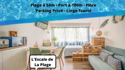 a room with a bed and a room with a table at L'Escale de la Plage in Gruissan