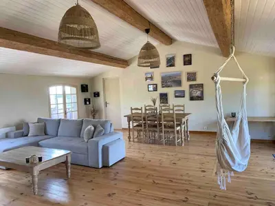 a living room with a couch and a table at Maison de village in Fanjeaux