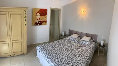 a bedroom with a bed and a cabinet in it at Appartement T3 centre ville in Narbonne