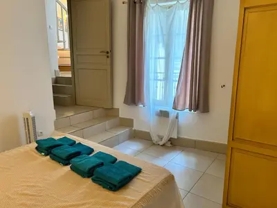 a room with a bed with green towels on it at Appartement T3 centre ville in Narbonne