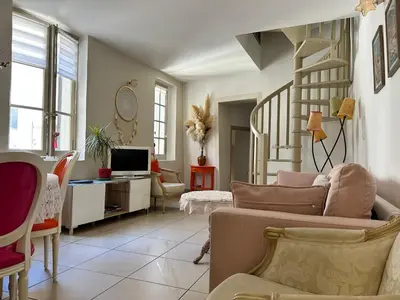 a living room with a couch and a staircase at Appartement T3 centre ville in Narbonne