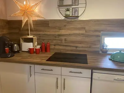 a kitchen with a counter with a wooden wall at Appartement T3 centre ville in Narbonne