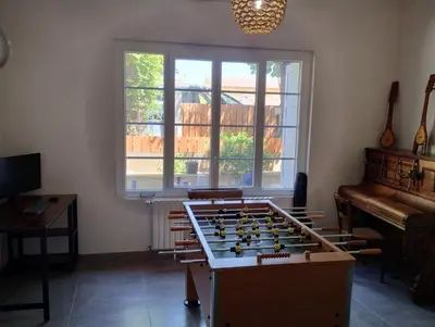 a living room with a foosball table and a piano at Grande Maison Vigneronne, proche de la mer in Salles-d'Aude