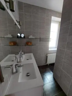 a white bathroom with two sinks and a window at Grande Maison Vigneronne, proche de la mer in Salles-d'Aude