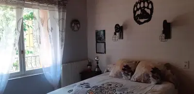 a bedroom with a bed and a window at Maison proche de la nature in Quérigut