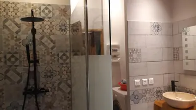 a bathroom with a shower and a sink at Maison proche de la nature in Quérigut