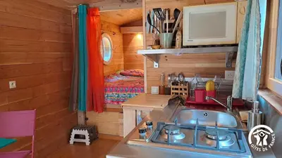 a kitchen with a sink in a tiny house at Terra bosca roulotte in Cambounès