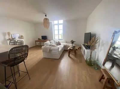 a living room with a white couch and a table at White Wood in Narbonne