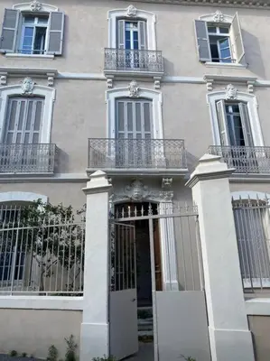 a large building with a door and a balcony at White Wood in Narbonne