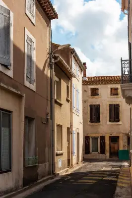an alley in an old town in italy at Maison avec piscine, vue sur le Canal du Midi in Capestang
