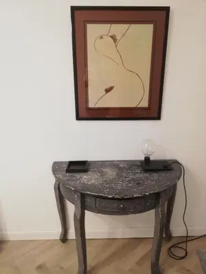 a table in a room with a picture on the wall at Les 3 Platanes in Conilhac-Corbières