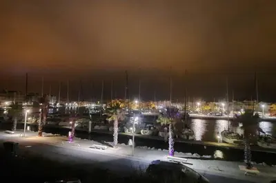 a marina at night with boats in the water at Appart. calme 5 Pers vue sur le port de gruissan in Gruissan
