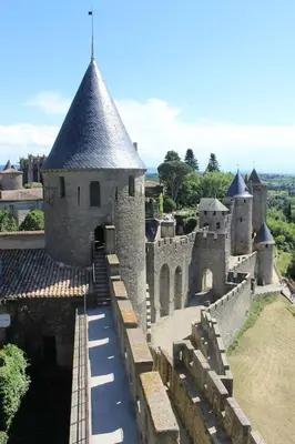 an old castle with a bridge in front of it at 2 bedroom home with shared pool in lovely market town of Olonzac in wine region in Olonzac