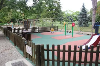 a playground with two play equipment in a park at 2 bedroom home with shared pool in lovely market town of Olonzac in wine region in Olonzac