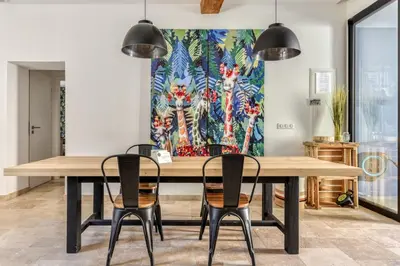a dining room with a large wooden table and chairs at La Remise des Amis - Proche du centre du village in Peyriac-de-Mer