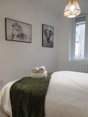 a bedroom with a bed with two towels on it at Le Jungle in Pamiers