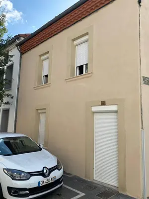 a white car parked in front of a building at Le Jungle in Pamiers