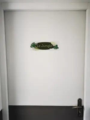 a white door with a sign on it at Le Jungle in Pamiers