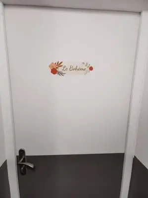 a bathroom door with a sign on it at Le Bohème in Pamiers
