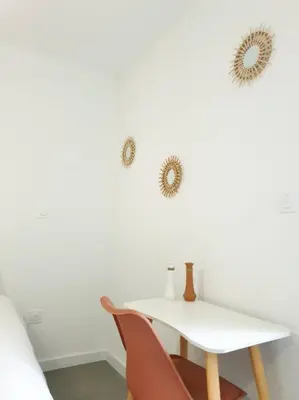 a white table and two mirrors on a wall at Le Bohème in Pamiers