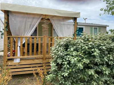 a gazebo with a canopy in front of a house at MH148 camping NOVELA - location entre particuliers-Mobil home 6pl climatisé - in Port-la-Nouvelle