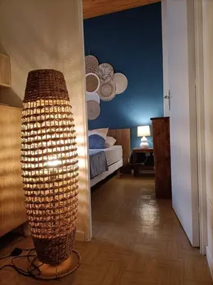 a room with a room with a bed and a lamp at Le Sept in Gruissan
