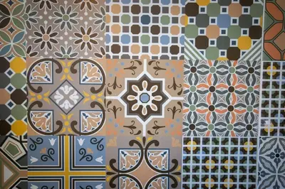 a group of different types of tiles on a wall at L'As de Carreaux in Narbonne