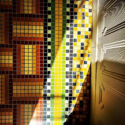 a stained glass window in a room next to a door at La Paloma La Palme in Lapalme