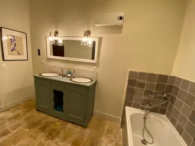 a bathroom with two sinks and a bath tub at La Paloma La Palme in Lapalme
