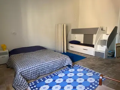 a bedroom with a bed and a dresser and a mirror at La Paloma La Palme in Lapalme
