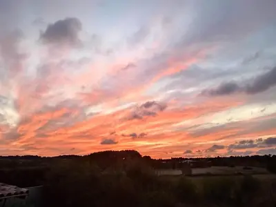 a sunset with colorful clouds in the sky at Au soleil couchant in Villemoustaussou